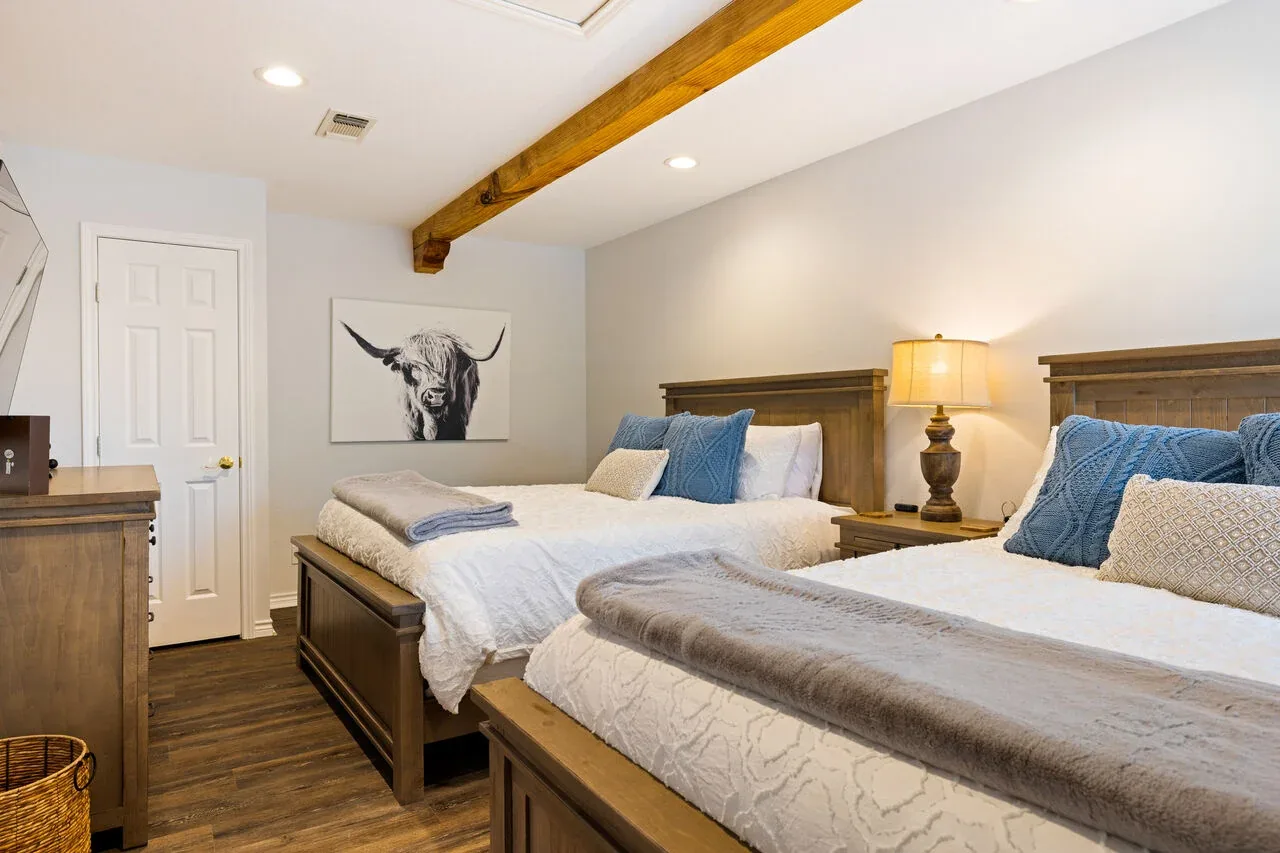 Guest bedroom with two beds and coordinated furnishings
