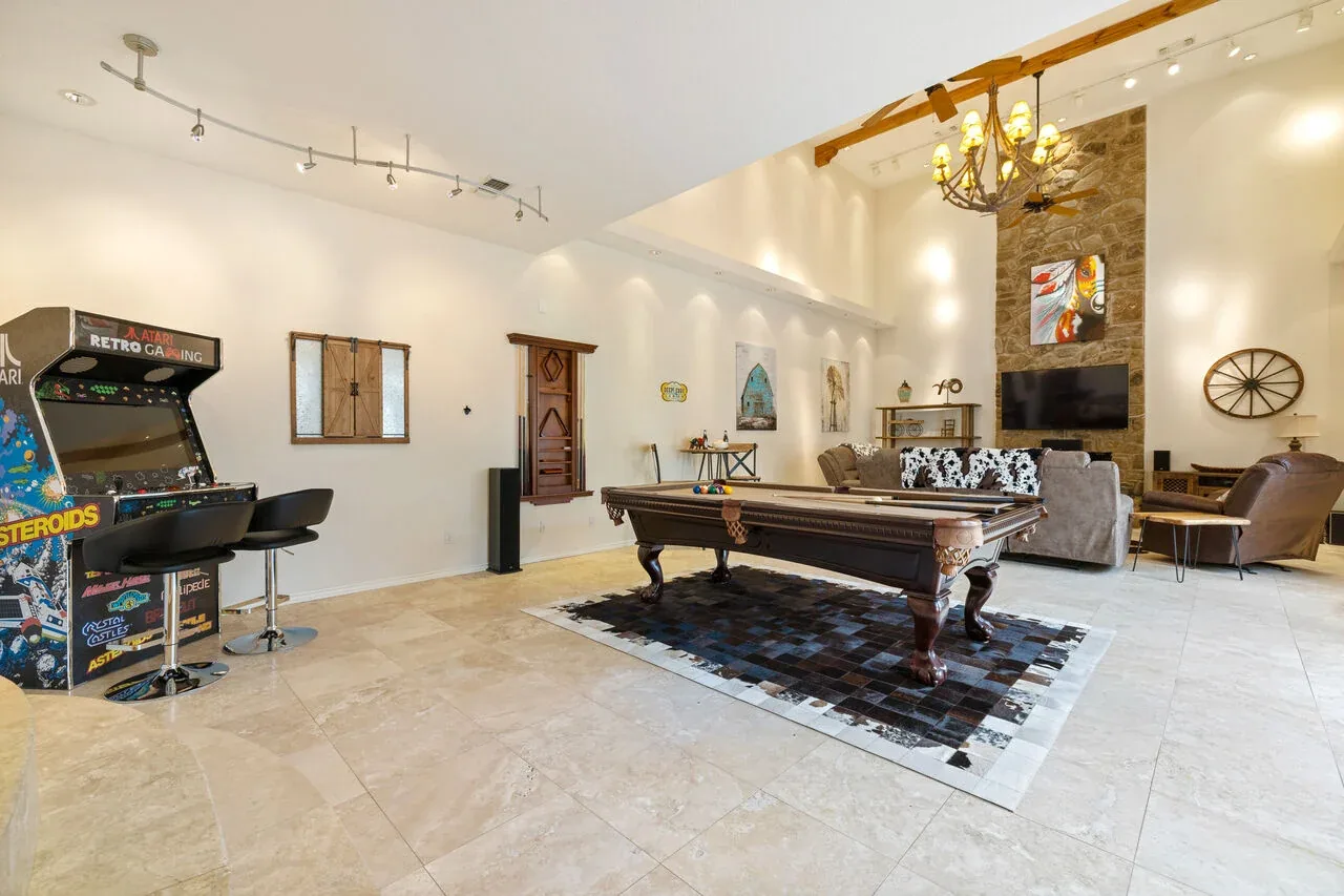 Large Texas game room with pool table and arcade games