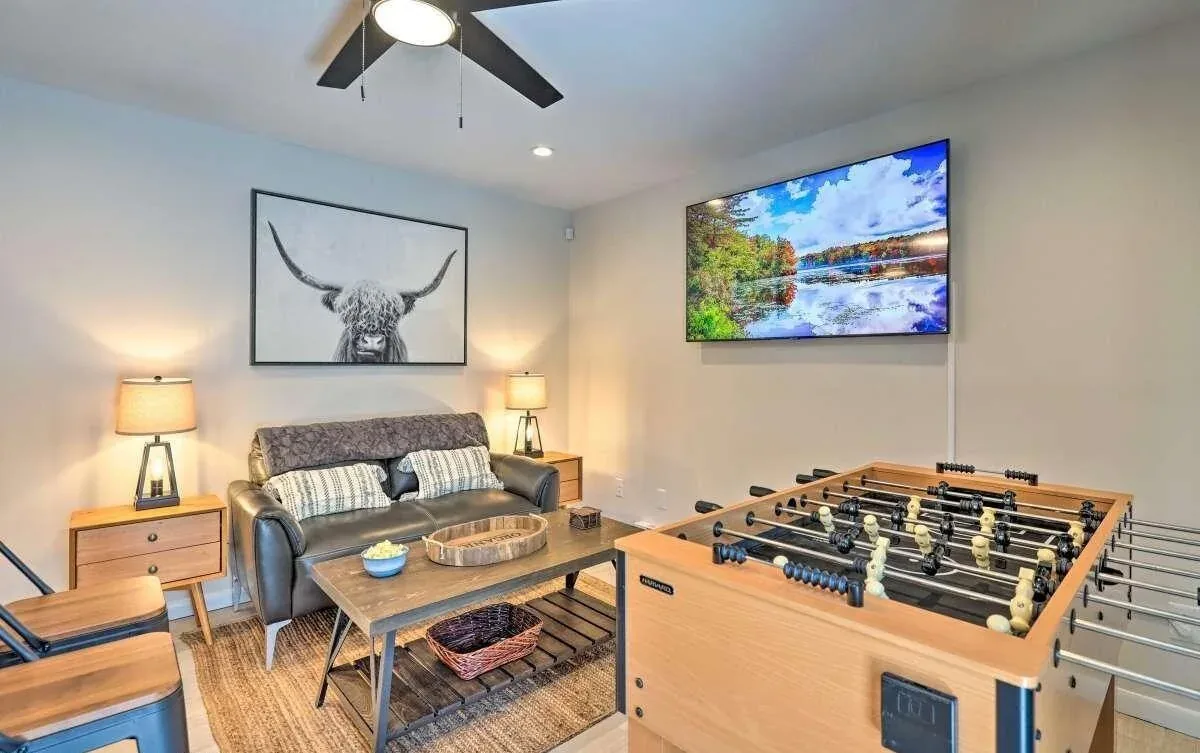 Poconos game room with foosball table, lounge seating, and wall-mounted television