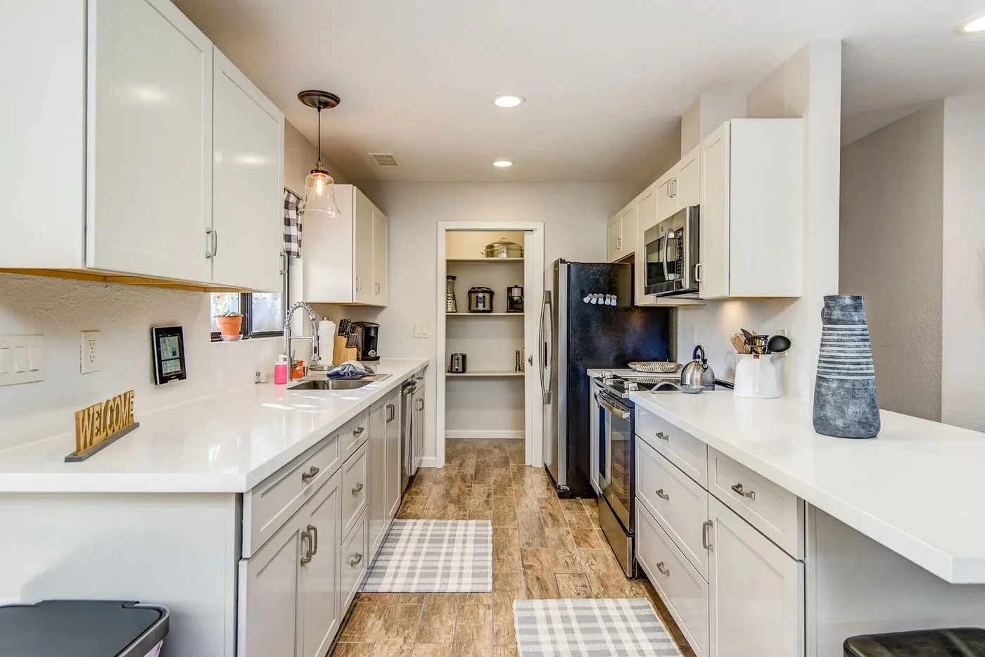 Sedona kitchen after renovation: white shaker cabinets, quartz counters, breakfast bar